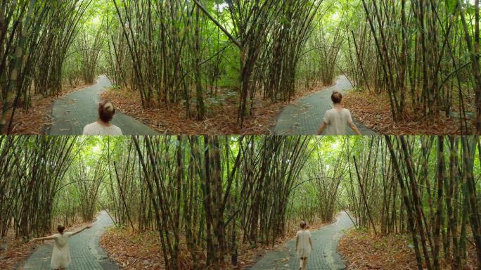 年轻女子伸开双臂在竹林中享受大自然的气息