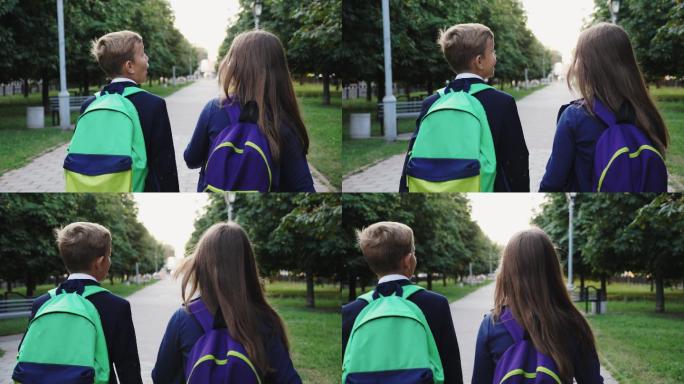 男孩和女孩拿着书包走路