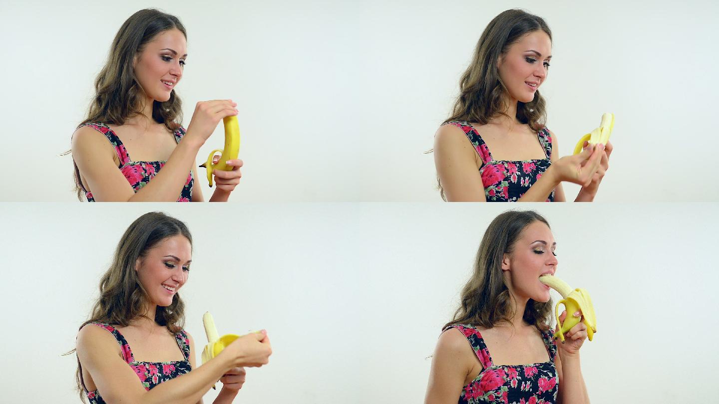 年轻快乐的女孩吃香蕉