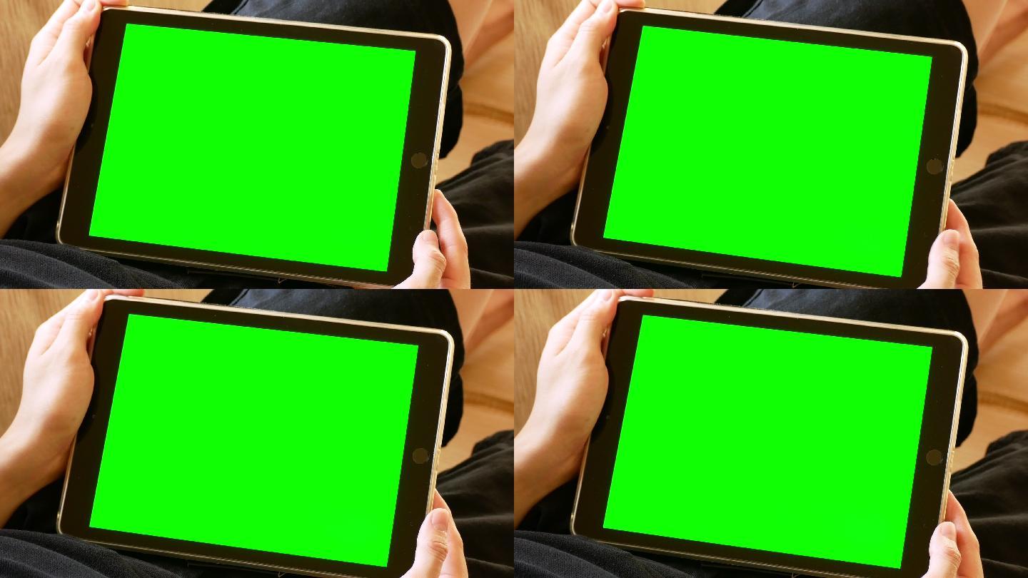 拿着绿色屏幕的数字平板电脑的男人