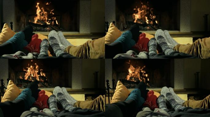 一个家庭在壁炉旁暖脚。