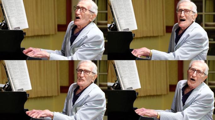 一名老年男子正在一边弹钢琴一边唱歌