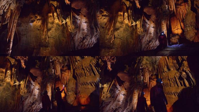 探险者在充满水滴的洞穴中行走