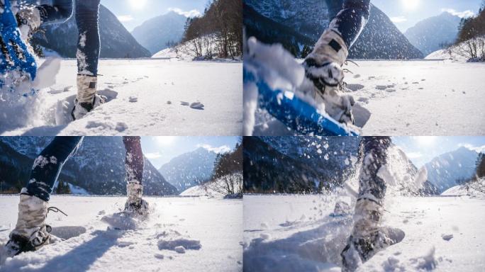 在雪地穿着雪鞋行走的女人