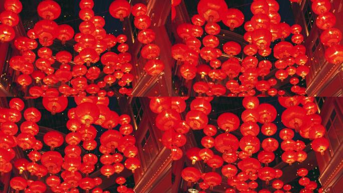 燃烧着红色的中国灯笼在城市街道上升起