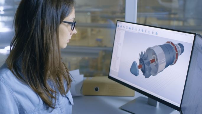 女工程师在她的电脑上用CAD软件做发动机