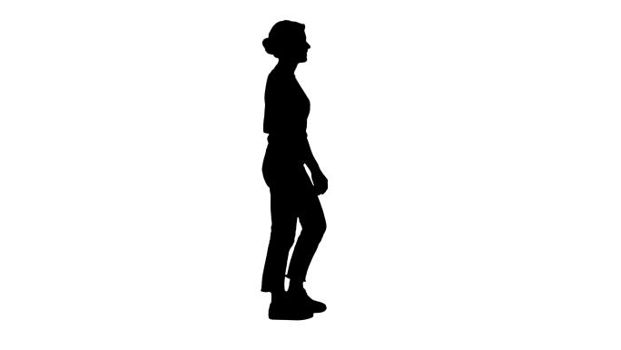 穿着t恤、牛仔裤和运动鞋的女人走路的剪影