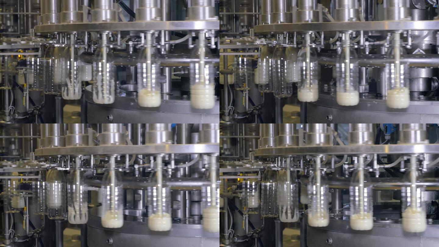 在牛奶生产厂的工业设备上把牛奶倒进瓶子里