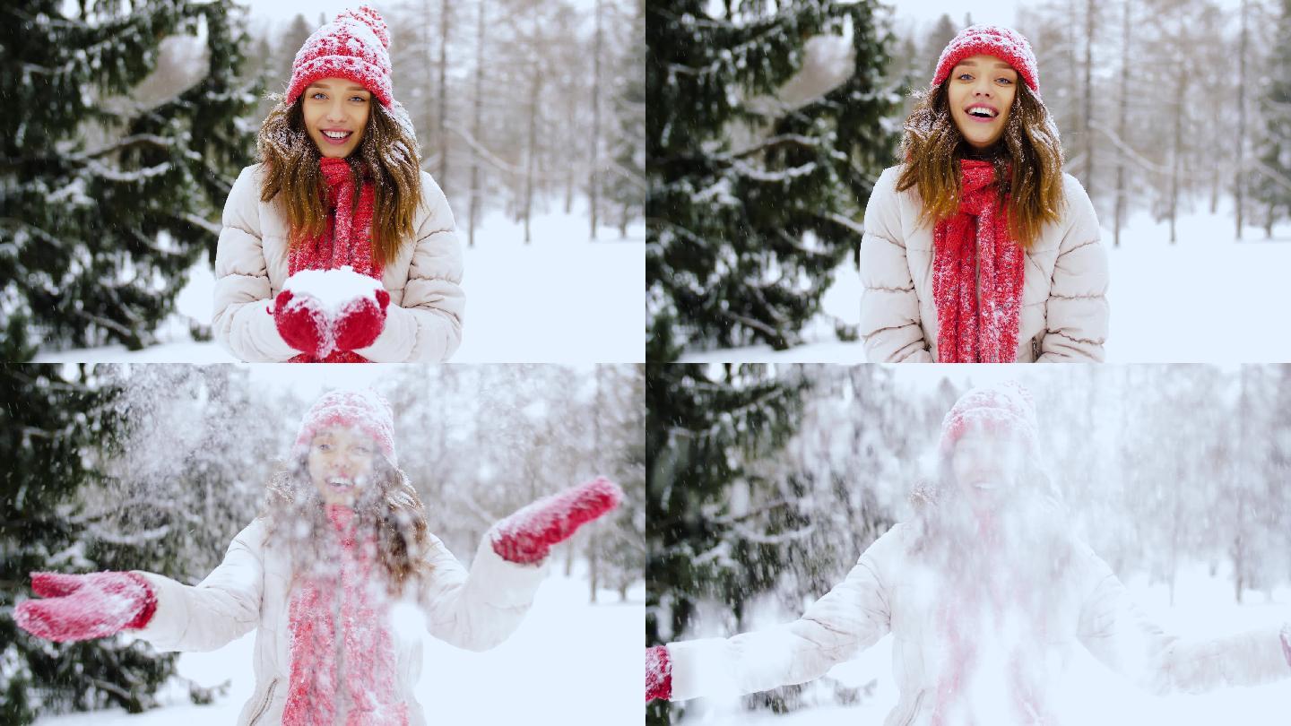 年轻女子捧着一把雪向上撒开