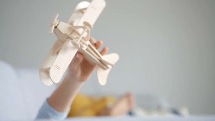 玩木制飞机玩具模型的男孩