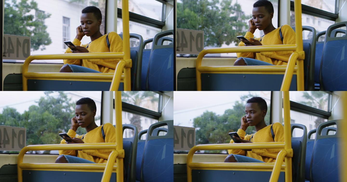 在公交车上使用手机的女人