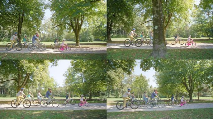 孩子们和父母、祖父母一起骑自行车穿过公园