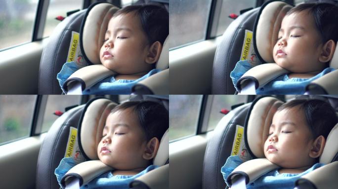 小孩坐在儿童车的座位上熟睡