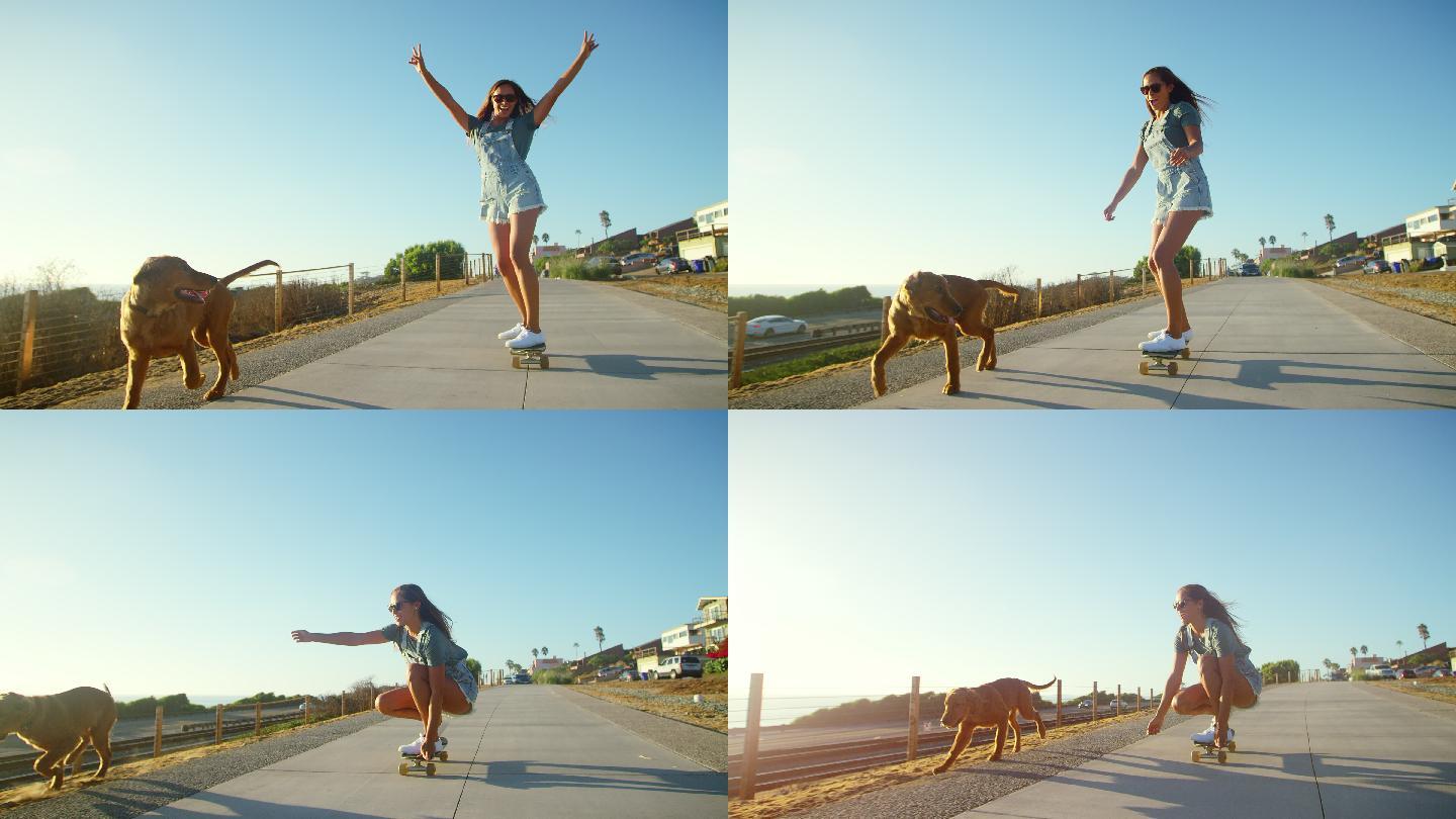 年轻快乐的女孩在日落时带着狗滑滑板