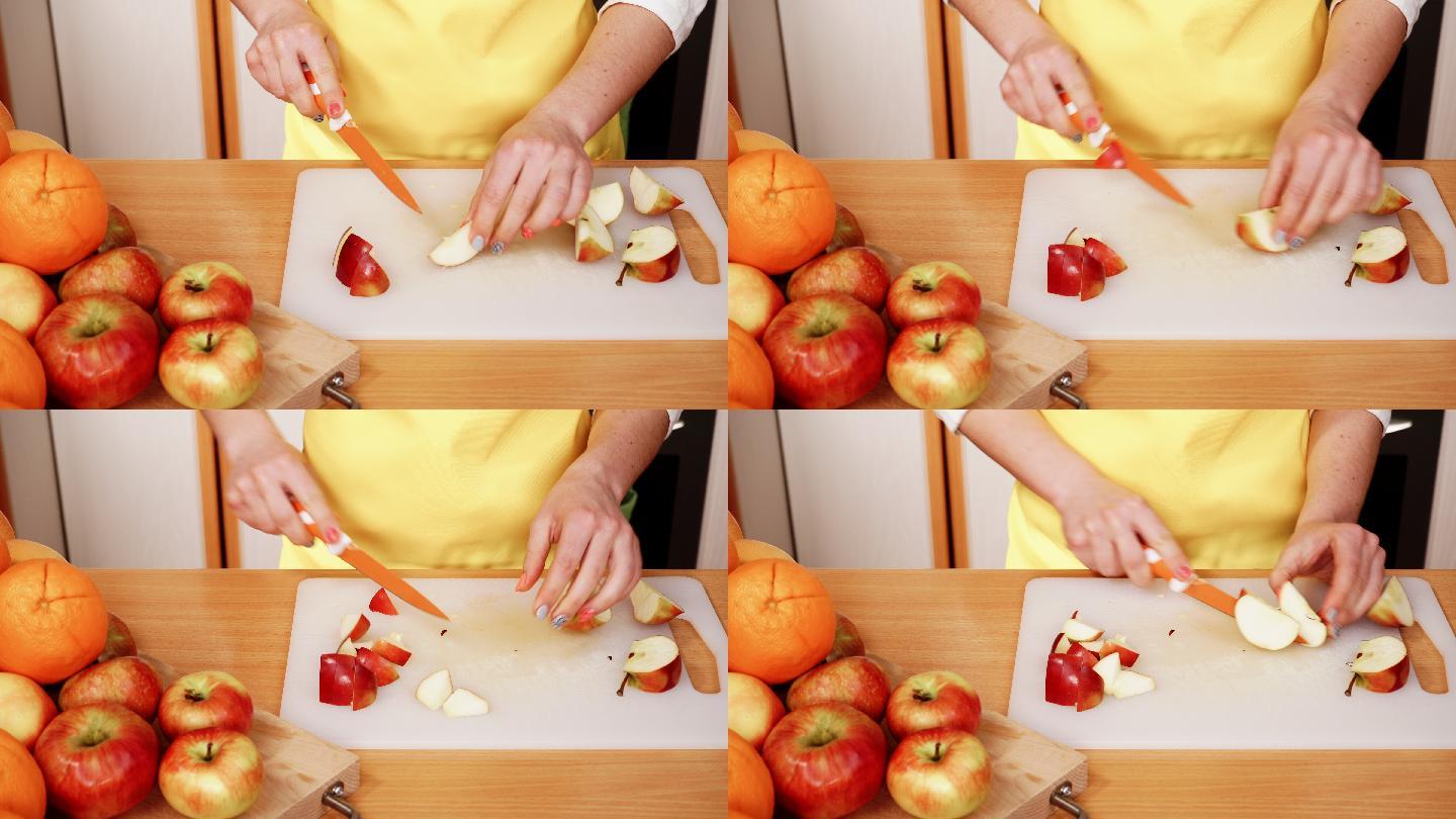家庭主妇在厨房切苹果