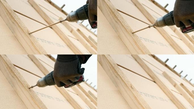 把一个长螺丝拧进屋顶木梁上的螺丝机