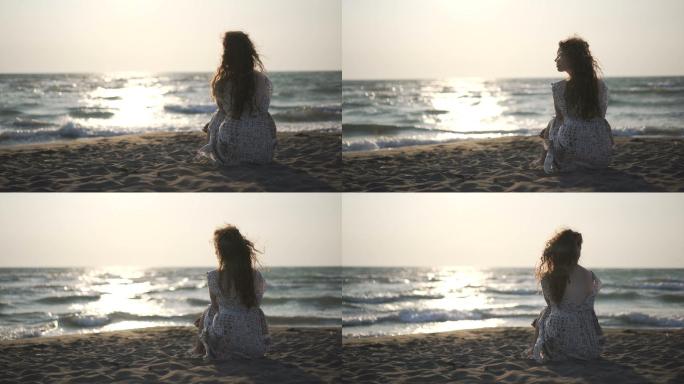 女子坐在沙滩上独自看风景