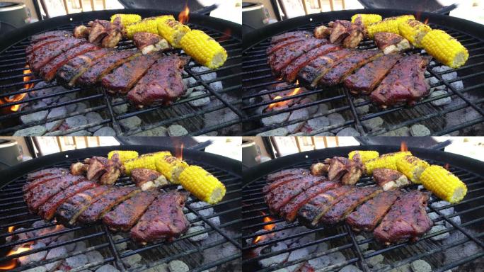 烤架上的烤猪排和玉米
