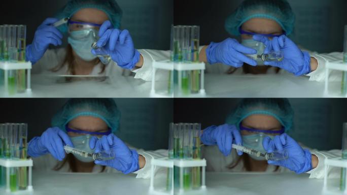 实验室助理从冰箱中取出疫苗并注射液体
