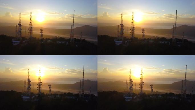 日出时电信杆电视天线的鸟瞰图