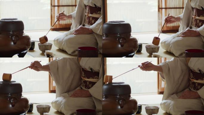 日本仪式主持人量茶碗里的水