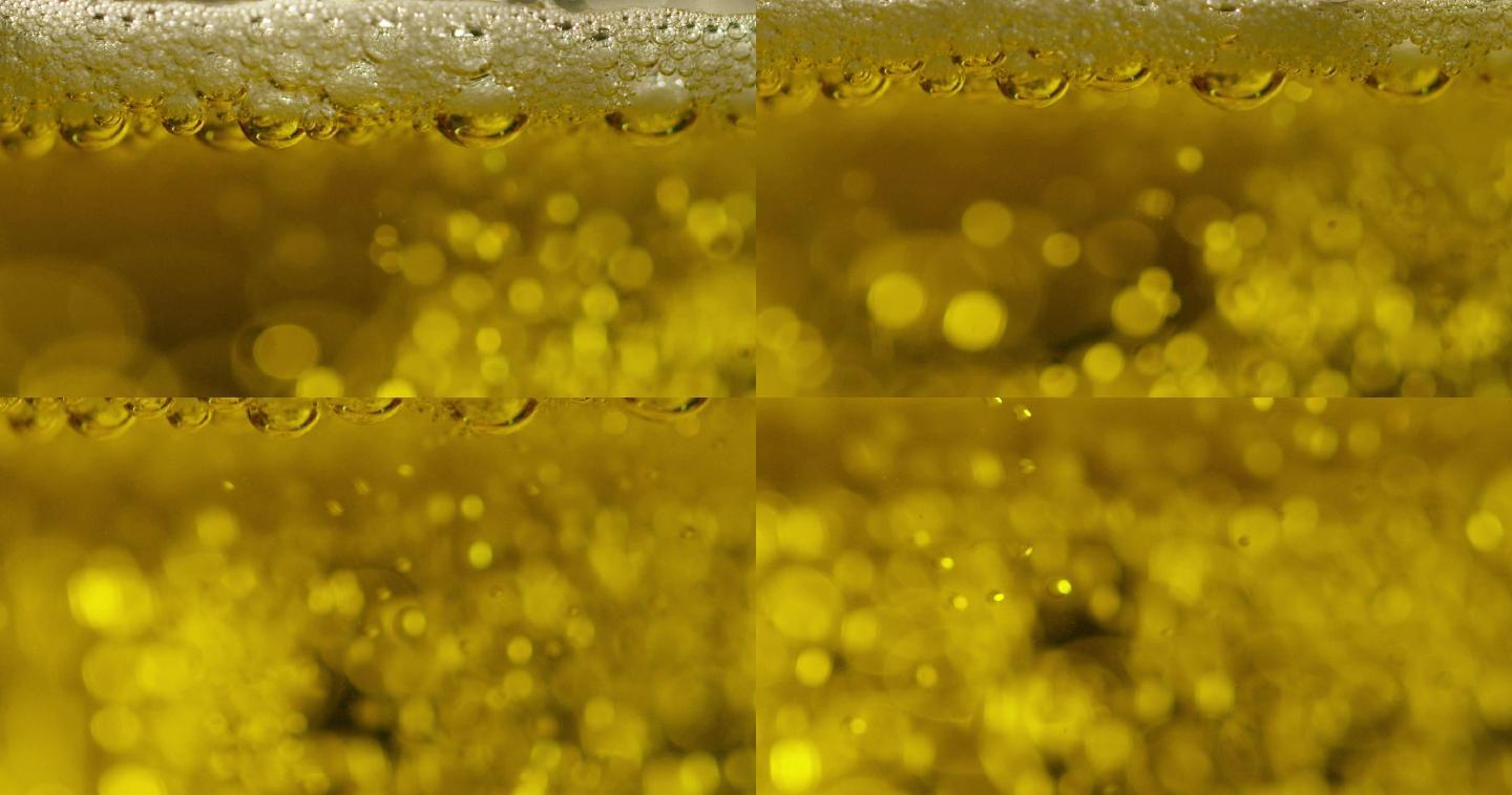 玻璃杯中黄色闪亮的啤酒气泡