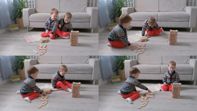 双胞胎男孩在地上搭积木