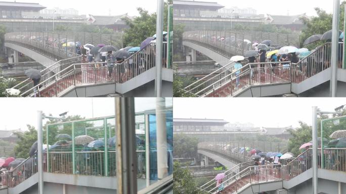 大暴雨行人打雨伞地铁过天桥上班