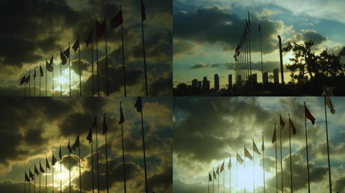 傍晚逆光拍摄的多国旗帜