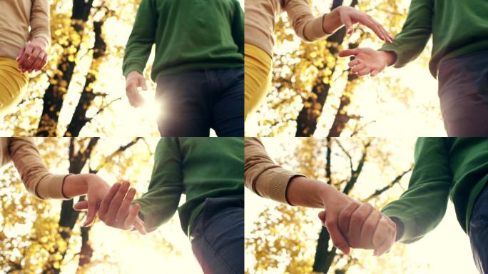 一对年轻夫妇在公园里手牵手