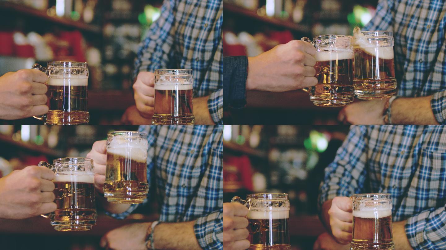 两个年轻人用啤酒敬酒的特写镜头。