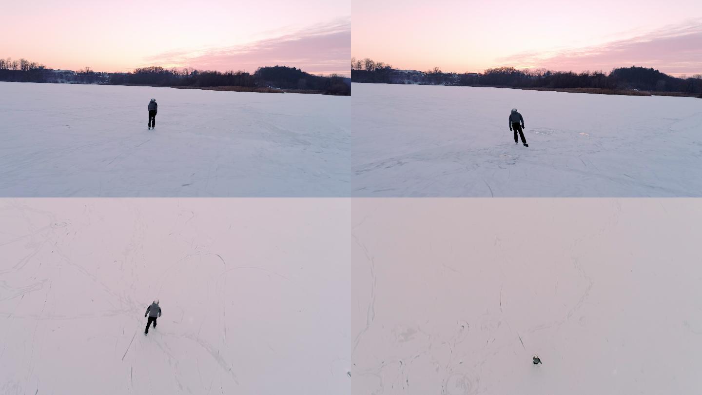 男孩在冰冻的湖面上滑冰