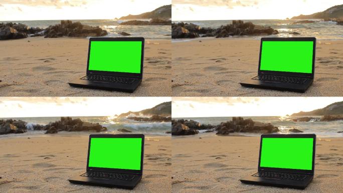 海滩上的绿色屏幕笔记本电脑