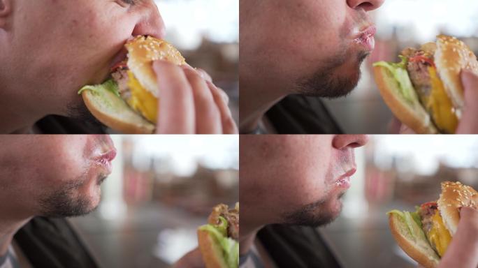 一名男子正在吃汉堡包。