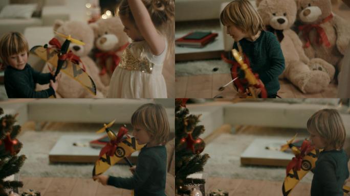 男孩得到玩具飞机作为圣诞节礼物