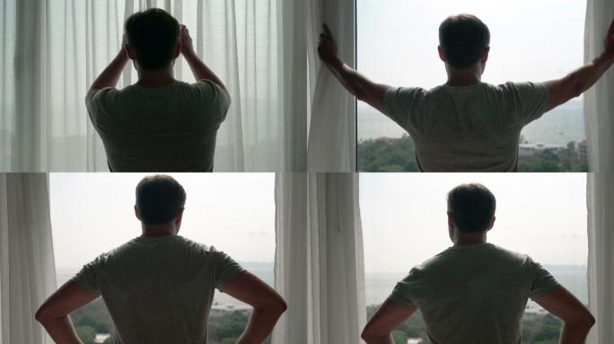 年轻人揭开窗帘，看着窗外。在外面欣赏海景