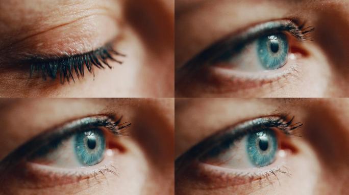 一位涂着睫毛膏的蓝眼睛女人睁开眼睛