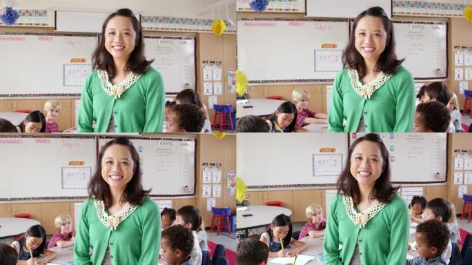 学校女教师在教室里冲着镜头微笑