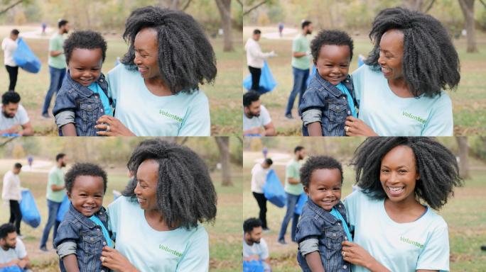 非洲裔美国妈妈在社区清洁日抱着男婴