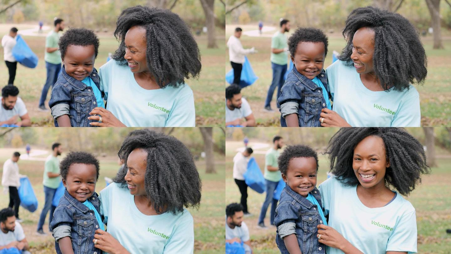 非洲裔美国妈妈在社区清洁日抱着男婴