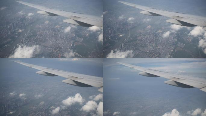 飞机舷窗俯瞰城市上空 在云端 机翼
