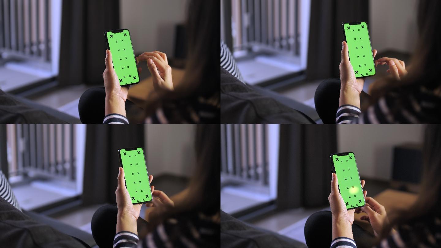 使用绿色屏幕智能手机的女性