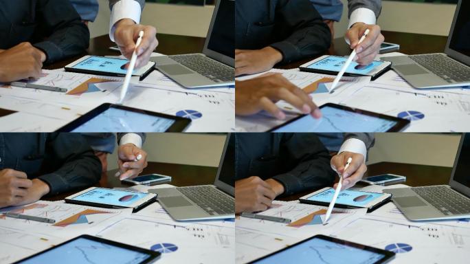 业务人员在办公桌上查看业务项目的图表文档