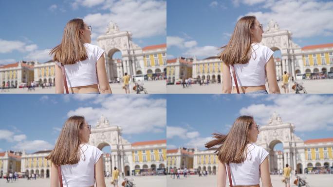 葡萄牙里斯本广场上一名女游客的后视图