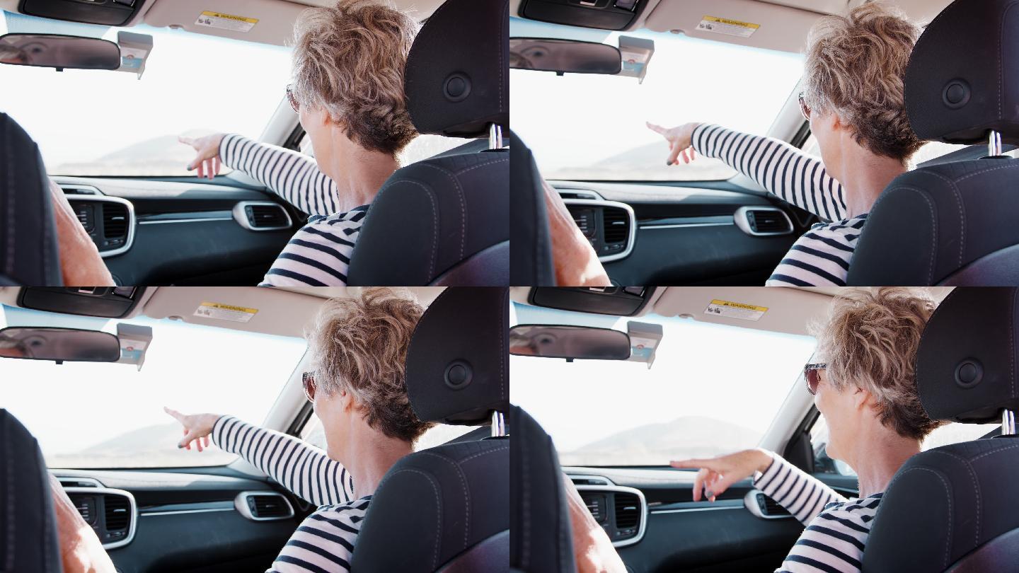 女人在副驾驶手指前方