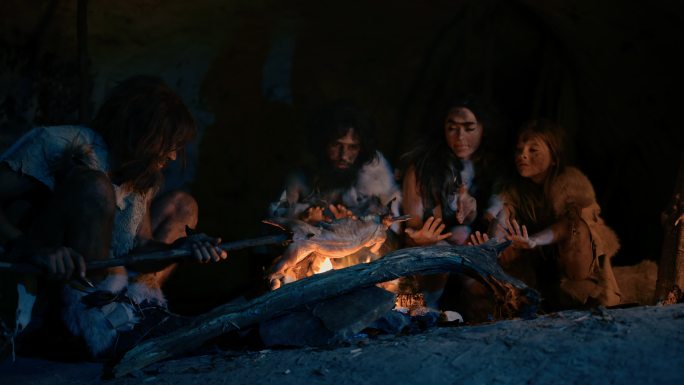 尼安德特人家庭在篝火上烹调