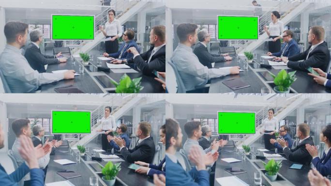 在会议室女高管使用绿色屏幕向同事展示内容