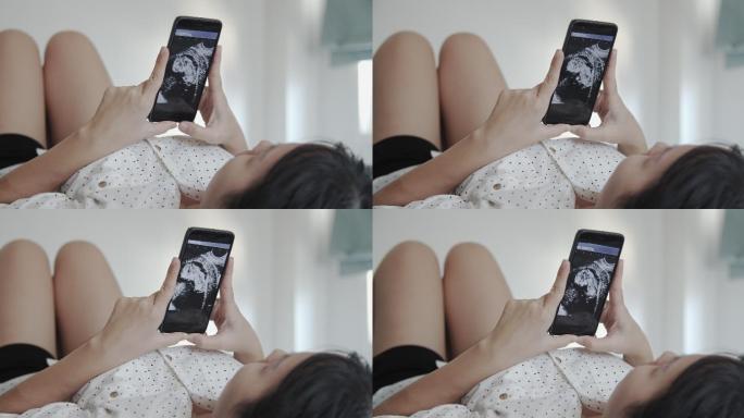 孕妇在手机上观的3D超声波视频
