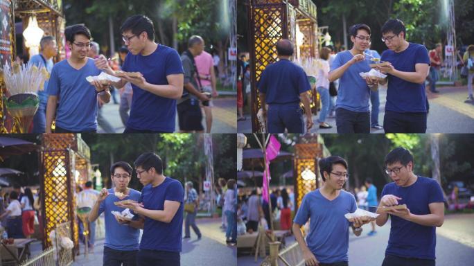 两名男子在泰国传统市场吃饭和交换食物