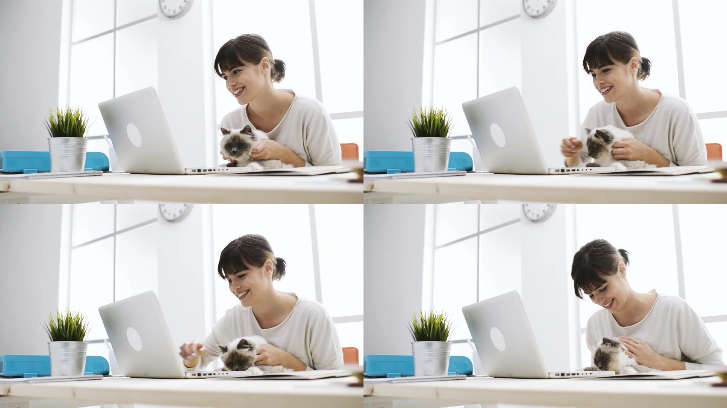 微笑的女性上网和拥抱她的猫